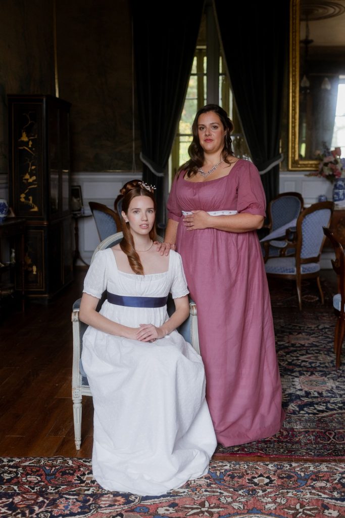 Séance photo Régence - Couple de femmes en tenue 1810 Bridgerton dans le salon d'un château